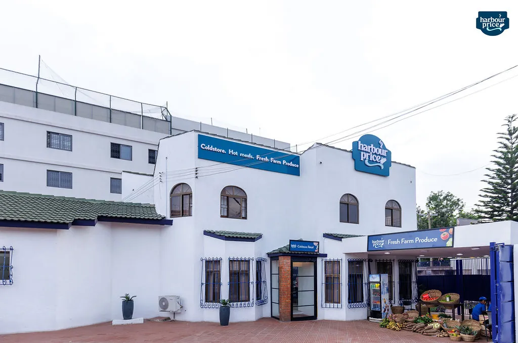 The Harbour Price building: white walls, blue signs for Coldstore, Hot meals and Fresh Farm Produce