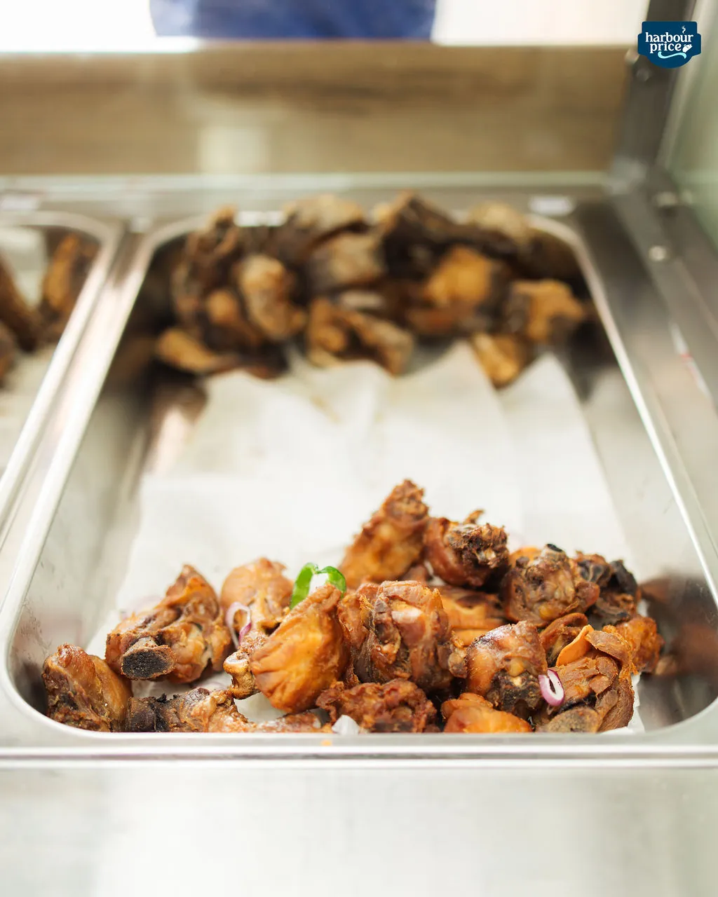 A tray of fried meat at the Harbour Price Hot Meals counter
