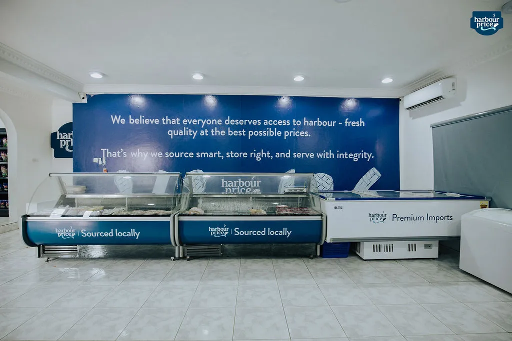 The bright Harbour Price cold store with rows of chest freezers under a blue wall