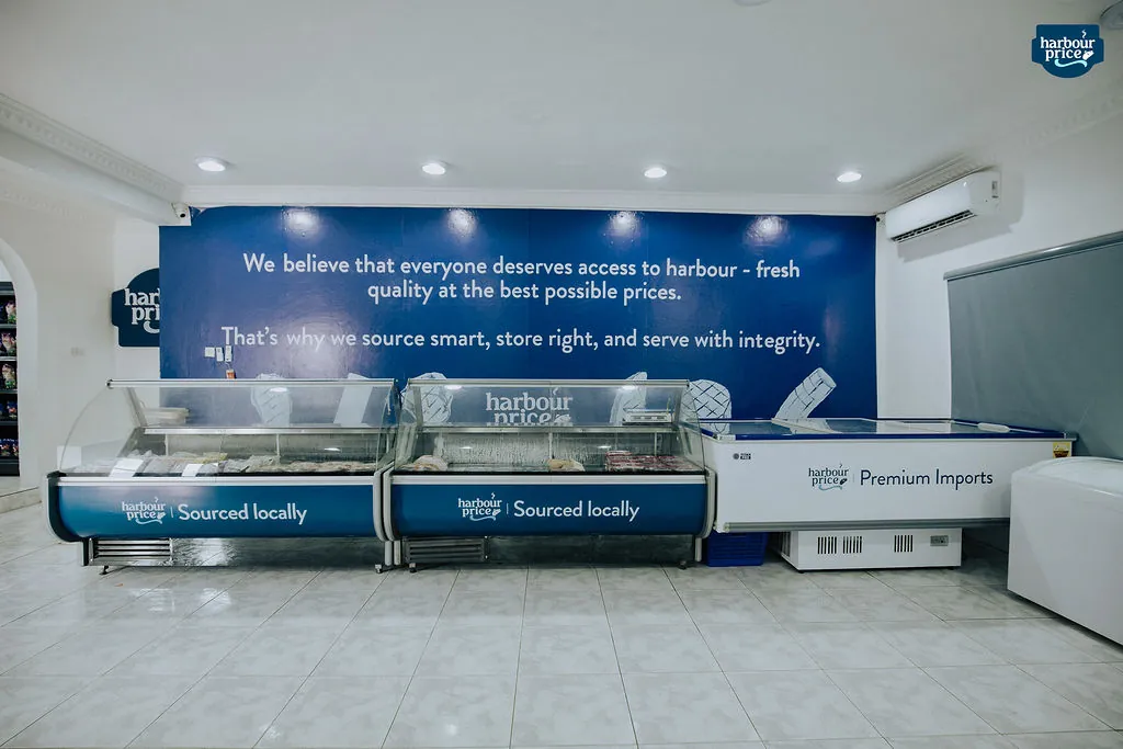 The Harbour Price cold store, with rows of chilled counters under the blue wall that carries our belief