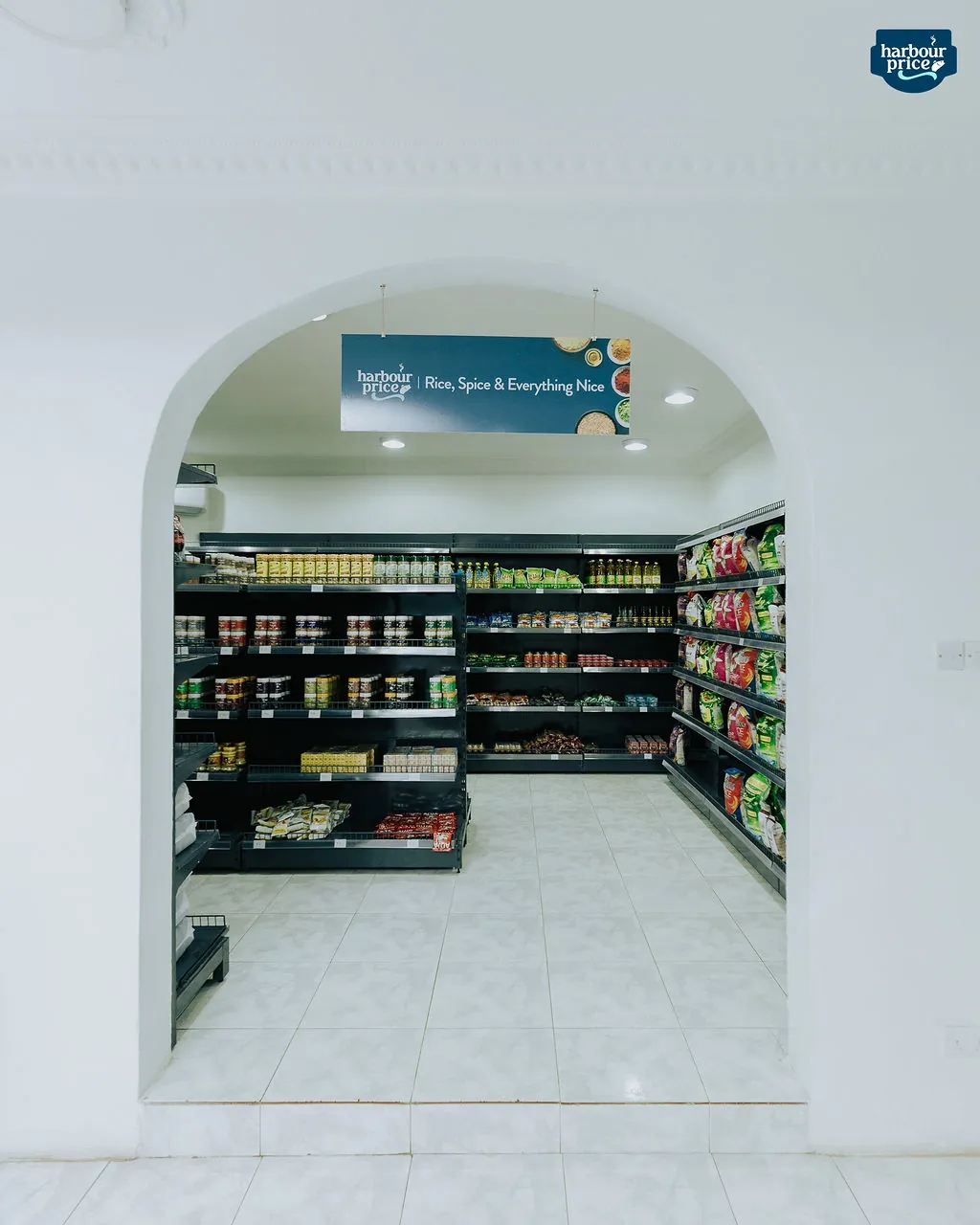 An arched doorway opening onto the grocery aisles