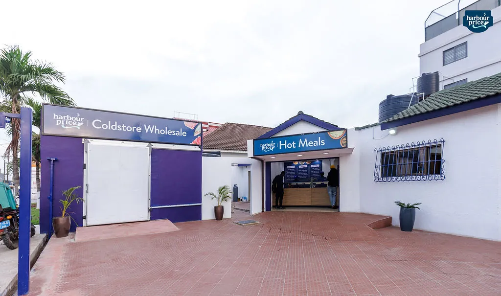The purple Coldstore Wholesale entrance beside the Hot Meals counter across the forecourt